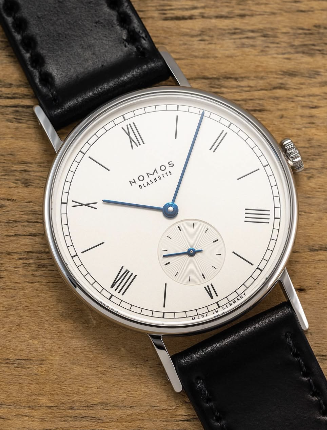 Nomos Glashütte Ludwig with Roman numerals and blued hands, on black leather over oak
