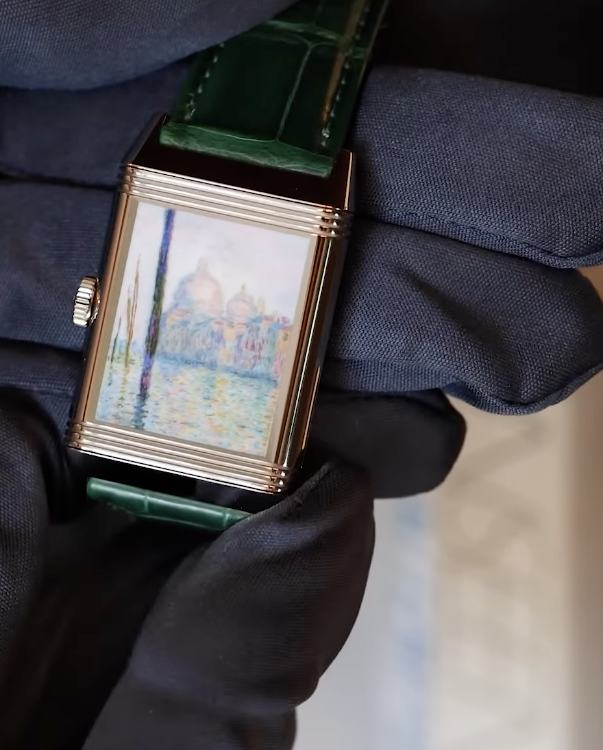 Jaeger-LeCoultre Reverso in rose gold on a green strap, its back enamelled with a Monet view of Venice, held in a gloved hand
